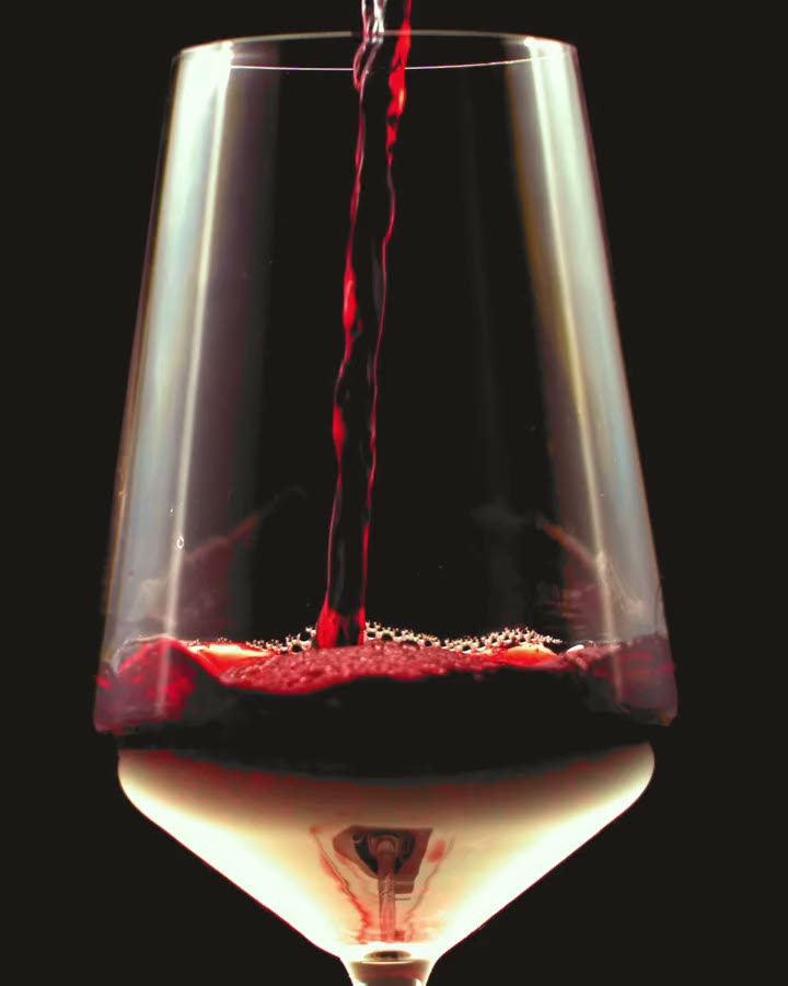 Red wine pouring into a glass
